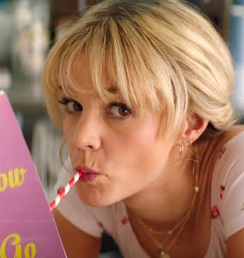 woman with blonde hair reading a book