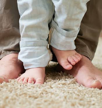 dad teaching his child to take step