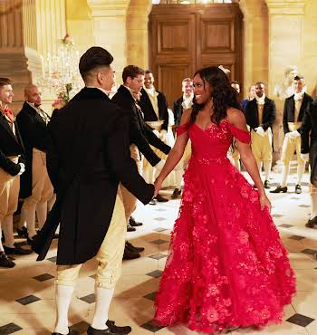 man in a suit and woman in a red dress dancing together