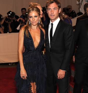 man and woman wearing black tie attire on the red carpet