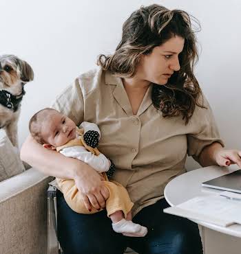 woman sat at computer with baby