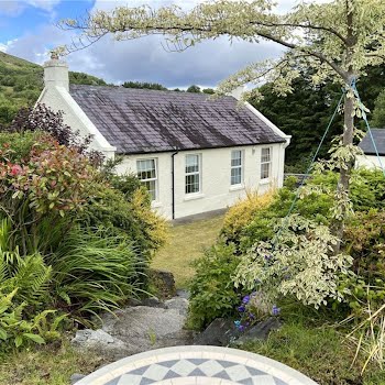 This cute country cottage with idyllic grounds filled with flowers is now on the market for €220,000