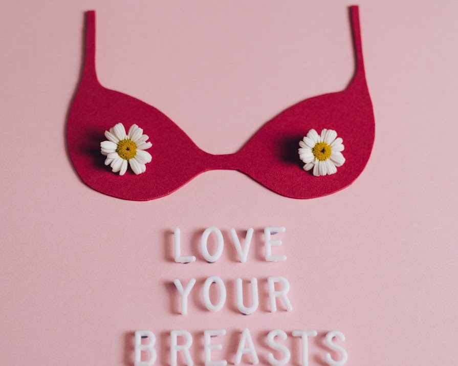 Premium Photo  Woman smiling and holding a bra against white background  concept of breast cancer awareness and international no bra day celebration