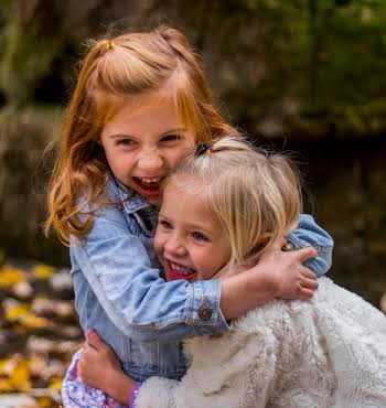 Two young girls hugging