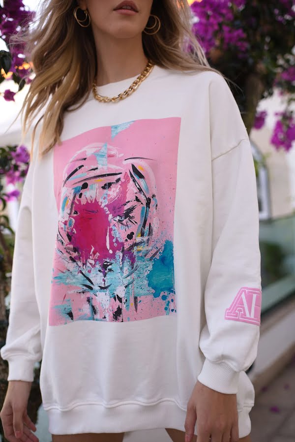 woman posing in colourful sweatshirt