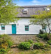 Nestled in the foothills Wicklow Mountains, this traditional thatched cottage is on the market for €380,000