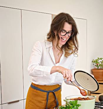 woman cooking dinner in her home kitchen