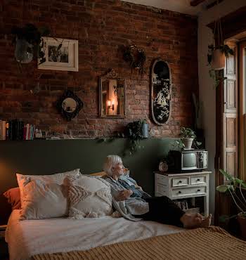 woman in bedroom looking out window