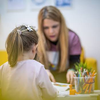 The educator works with a small child in a children's workshop