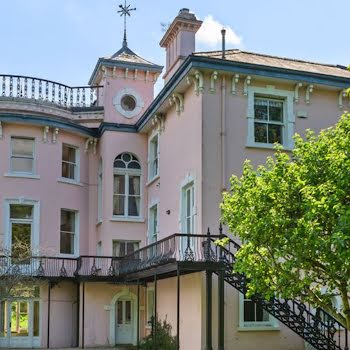 This powder pink Blackrock home has an extensive library and beautiful cast iron balcony