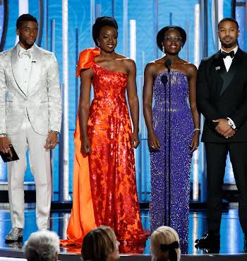 four people on stage at the Golden Globes awards cermemony