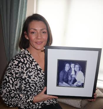 Barbara Brown holding a photo of her sister Sinead who died from skin cancer