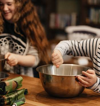 two young children cooking together