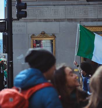 group of people holding an Irish flag