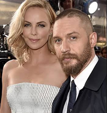 blonde woman and man with beard pose together for a photograph